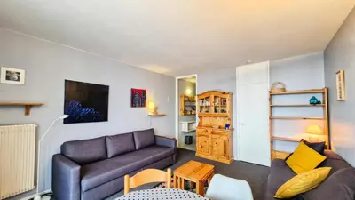 a living room with a couch and a table at Résidence Vega - Studio lumineux · Proche des pistes et des commerces · Balcon MAE-1641 in Magland