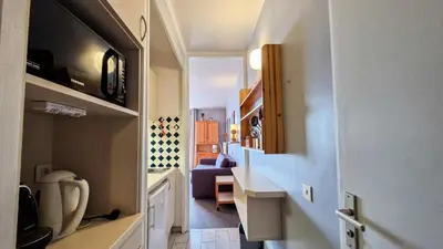 a hallway leading to a room with a living room at Résidence Vega - Studio lumineux · Proche des pistes et des commerces · Balcon MAE-1641 in Magland