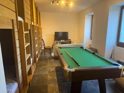 a room with a pool table and some shelves at Chalet La Foge - Samoens x 14, skis aux pieds in Morillon