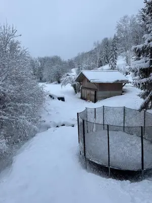 a barn covered in snow next to a fence at Chalet La Foge - Samoens x 14, skis aux pieds in Morillon