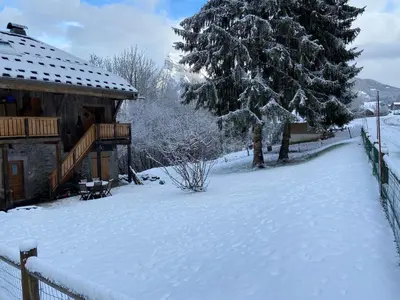 a yard covered in snow next to a house at Chalet La Foge - Samoens x 14, skis aux pieds in Morillon