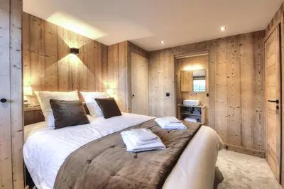 a bedroom with a large bed with wooden walls at Picherie bas - 10Pax - Calme - Vue montagne in Saint-Gervais-les-Bains