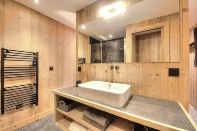 a bathroom with a sink and wooden walls at Picherie bas - 10Pax - Calme - Vue montagne in Saint-Gervais-les-Bains