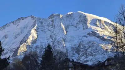 a snow covered mountain with a house in front of it at Picherie bas - 10Pax - Calme - Vue montagne in Saint-Gervais-les-Bains