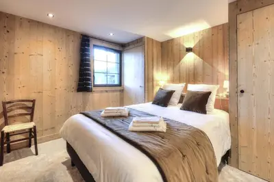 a bedroom with a large bed with two towels on it at Picherie bas - 10Pax - Calme - Vue montagne in Saint-Gervais-les-Bains