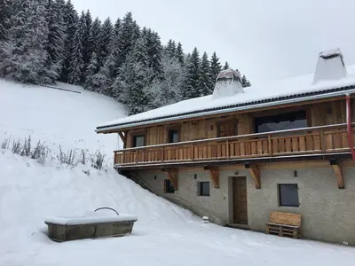 a building covered in snow with a tub at Picherie bas - 10Pax - Calme - Vue montagne in Saint-Gervais-les-Bains