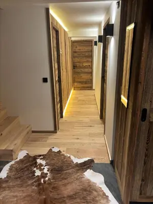 a hallway of a house with wooden floors and wooden walls at Chalet Le 1853 in Chamonix-Mont-Blanc