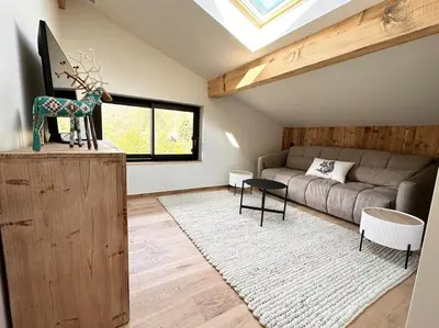 a living room with a couch and a table at Chalet Le 1853 in Chamonix-Mont-Blanc