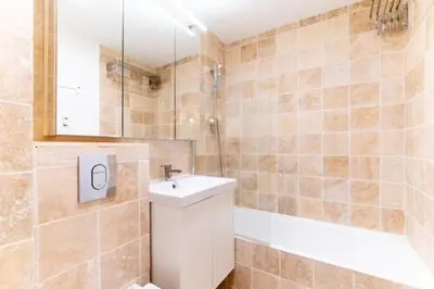 a bathroom with a sink and a bath tub at Appartement à Megève skis aux pieds - La CABOCHE in Le Planellet