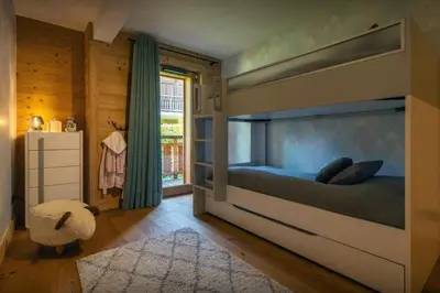 a bedroom with a large bed in a room at Sundance Kid Loft - OVO Network in Megève