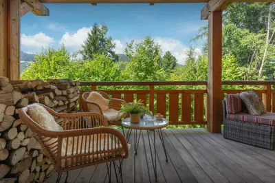 a screened in porch with chairs and a table at Sundance Kid Loft - OVO Network in Megève