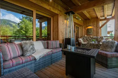 a living room with a couch and a table at Sundance Kid Loft - OVO Network in Megève