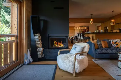 a living room with a couch and a fireplace at Sundance Kid Loft - OVO Network in Megève