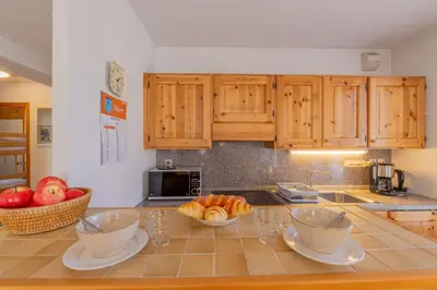 a kitchen counter with a bowl of fruit and a basket of bread at Appartement De l'Aiguille Du Midi - Happy Rentals in Chamonix-Mont-Blanc