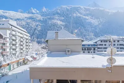 a view of a building with snow on the roof at Appartement De l'Aiguille Du Midi - Happy Rentals in Chamonix-Mont-Blanc