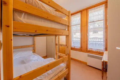 a bunk bed room with two bunk beds at Appartement De l'Aiguille Du Midi - Happy Rentals in Chamonix-Mont-Blanc
