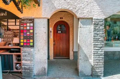 a wooden door in a building with a store at Le Rocher - Chamonix Hypercentre - Refait à Neuf in Chamonix-Mont-Blanc