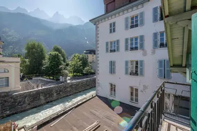 a living room with two red couches and a table at Spacious loft on pedestrian street with views in Chamonix-Mont-Blanc
