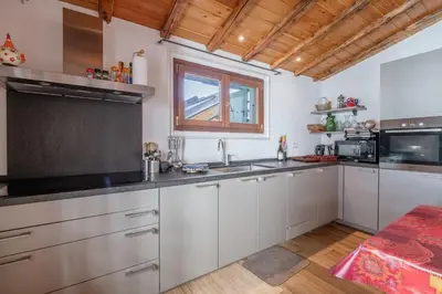 a living room with a table and a couch at Spacious loft on pedestrian street with views in Chamonix-Mont-Blanc
