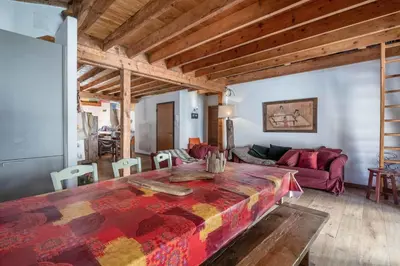 a living room with a couch and a table at Spacious loft on pedestrian street with views in Chamonix-Mont-Blanc