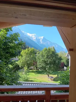 a view of a mountain from the porch of a house at Chalet rinette in Chamonix-Mont-Blanc