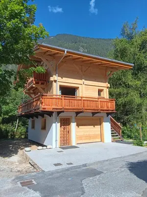 a house with a balcony and a garage at Chalet rinette in Chamonix-Mont-Blanc