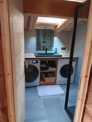 a kitchen with a sink and a washing machine at Chalet rinette in Chamonix-Mont-Blanc