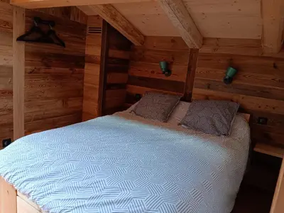 a bedroom with a bed in a log cabin at Chalet rinette in Chamonix-Mont-Blanc