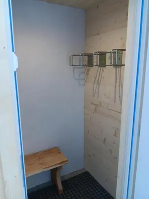 a room with a wooden wall with a bench at Chalet rinette in Chamonix-Mont-Blanc
