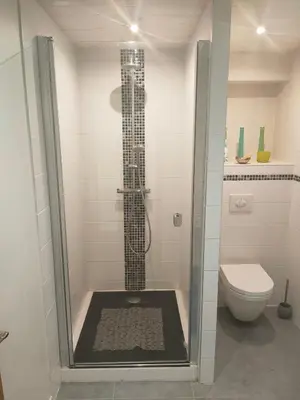 a shower stall in a bathroom with a toilet at Beau studio dans la vallée de CHAMONIX in Les Houches