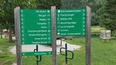 a bunch of green signs in a park at Studio cosy au pied des remontées,wifi,smart TV,parking in Les Contamines-Montjoie