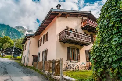 a living room with a couch and a table at Le Hameau de Taconnaz - Calme - Charme in Les Houches