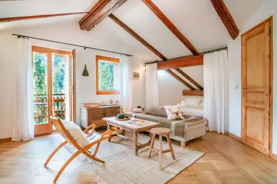 a living room with a couch and a table at Le Hameau de Taconnaz - Calme - Charme in Les Houches