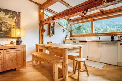 a living room with a couch and a table at Le Hameau de Taconnaz - Calme - Charme in Les Houches