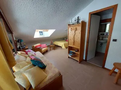 a bedroom with a bed and a room with a mirror at Les Appartements Diochon in Le Baplieu