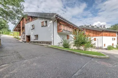 an empty street in front of a house at Appartement du Meu - Welkeys in Megève