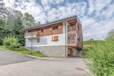 a building with a balcony on the side of it at Appartement Crystal - 4 étoiles - Welkeys in Megève
