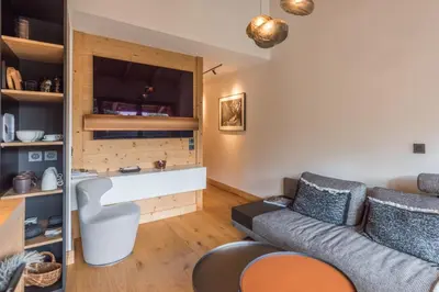a living room with a couch and a chair at Appartement Crystal - 4 étoiles - Welkeys in Megève