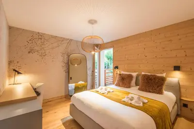 a bedroom with a large bed with towels on it at Appartement Crystal - 4 étoiles - Welkeys in Megève