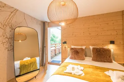 a bedroom with a large mirror and a bed at Appartement Crystal - 4 étoiles - Welkeys in Megève