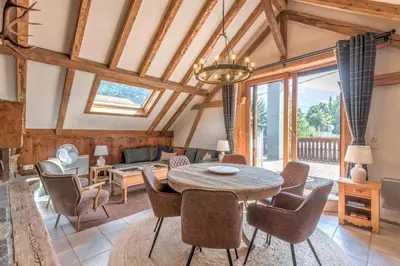 a living room with a table and chairs at Appartement du Rosay - Welkeys in Saint-Gervais-les-Bains