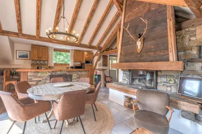 a dining room with a table and a fireplace at Appartement du Rosay - Welkeys in Saint-Gervais-les-Bains