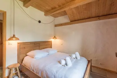 a bedroom with a bed with white sheets and pillows at Appartement du Rosay - Welkeys in Saint-Gervais-les-Bains