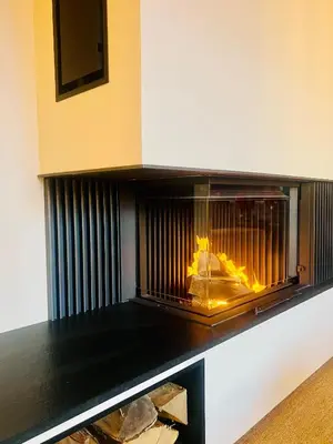 a fireplace with a fire inside of it at Loue chalet Megève proximité pistes Rochebrune et centre-ville in Megève