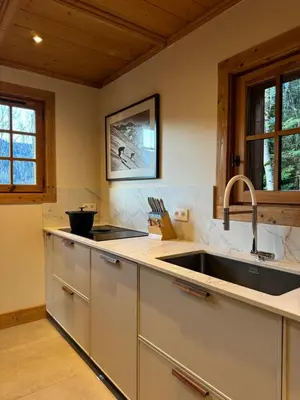 a kitchen with a sink and a counter top at Loue chalet Megève proximité pistes Rochebrune et centre-ville in Megève