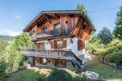a large wooden house with a balcony at Loue chalet Megève proximité pistes Rochebrune et centre-ville in Megève