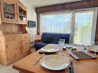 a dining room table with plates and glasses on it at Appartement T3 familial rénové à Samoëns, animaux acceptés - FR-1-624-161 in Samoëns