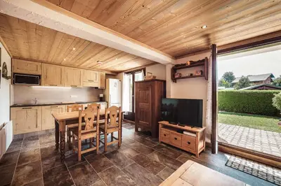 a kitchen and dining room with a table and a television at Flat Sofia - Authentic charm in Demi-Quartier