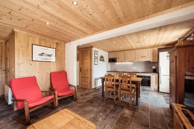a kitchen with a table and red chairs in a room at Flat Sofia - Authentic charm in Demi-Quartier