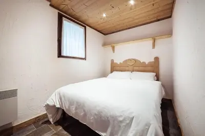 a bedroom with a white bed and a window at Flat Sofia - Authentic charm in Demi-Quartier